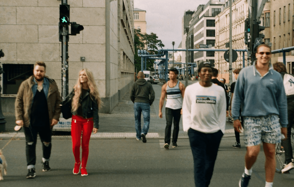 People walking across a busy city street at a green pedestrian light